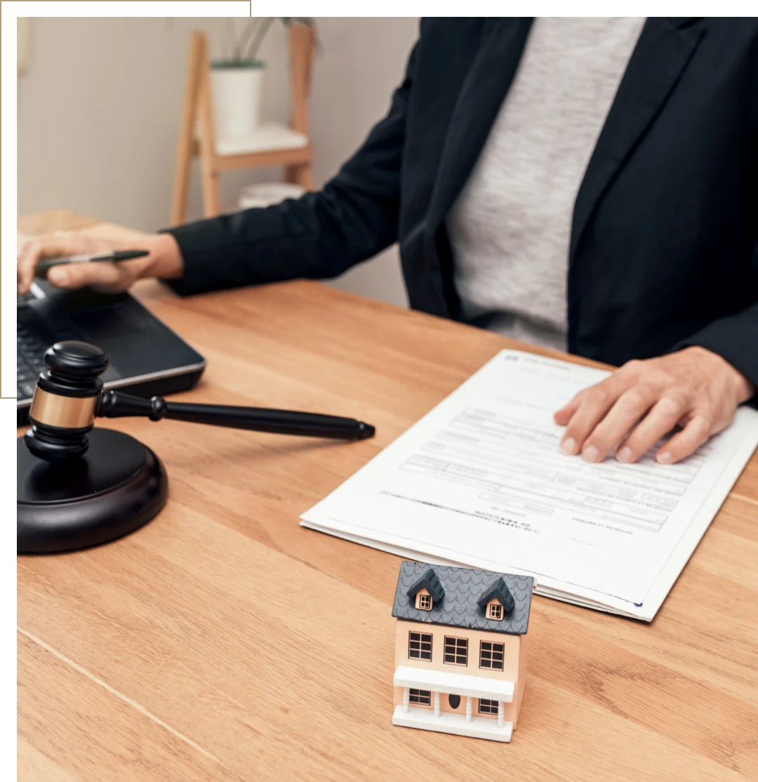 Gavel and house model on desk