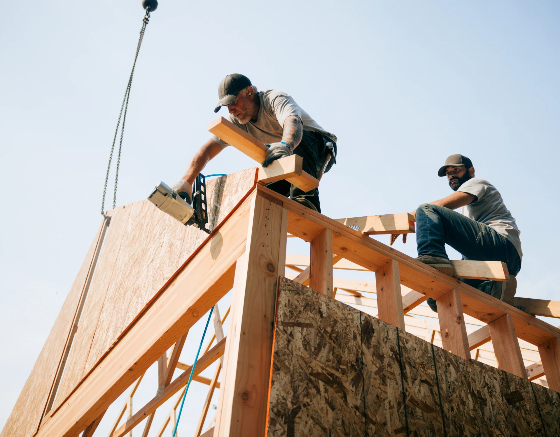 Construction workers building wooden framework